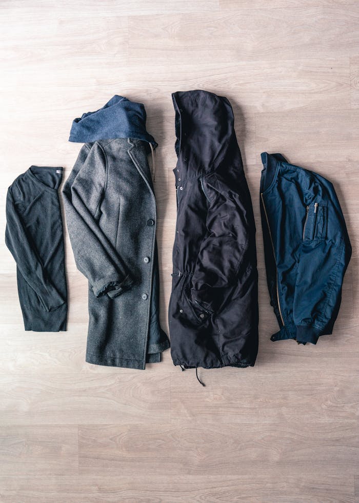 A trendy flat lay showcasing a selection of modern outerwear pieces for fashion enthusiasts.
