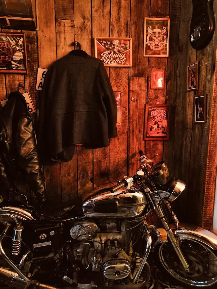 A cozy indoor setting featuring a vintage motorcycle and rustic decor on a wooden wall.